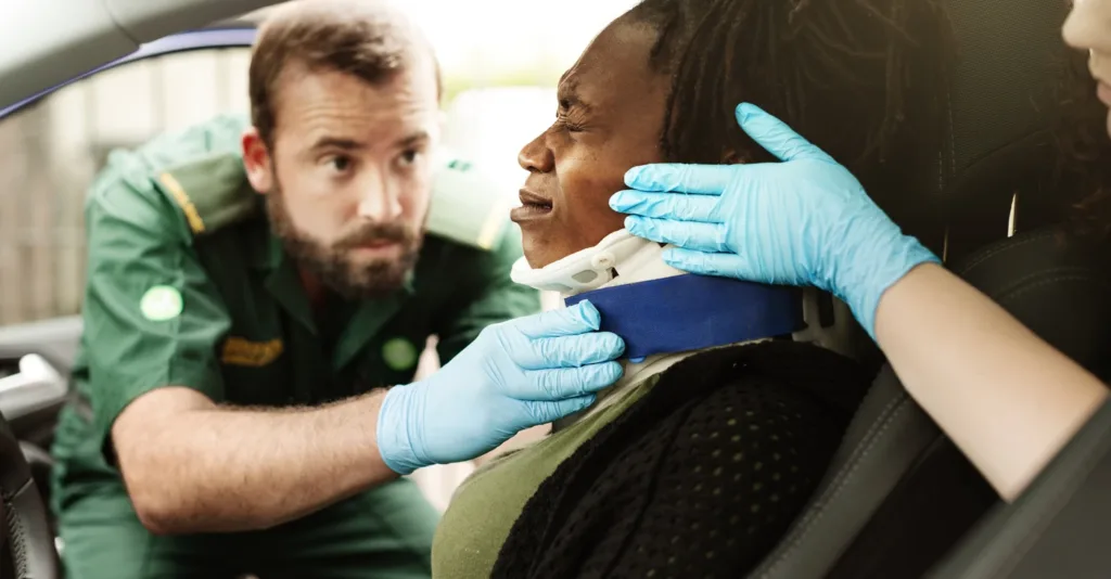 paramedic_assists_injured_person_car_emergency_care_neck_brace_medical_attention