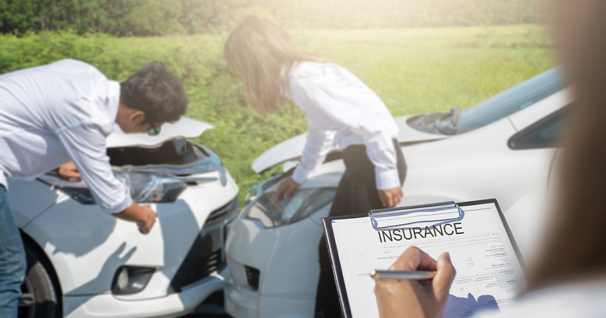 Drivers reviewing crash damage related to insurance premium increases