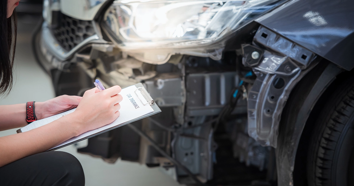 Insurance adjuster reviewing vehicle damage after Houston accident