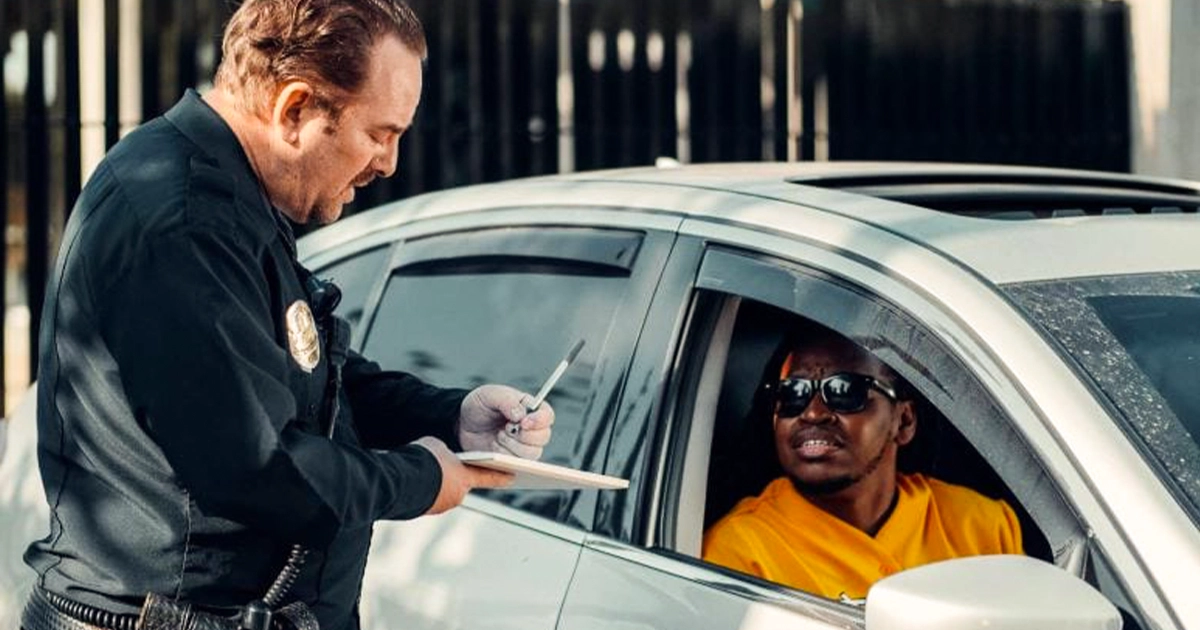 Police officer issuing a speeding ticket to driver