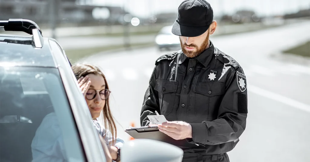 Officer issuing a traffic citation for a violation.